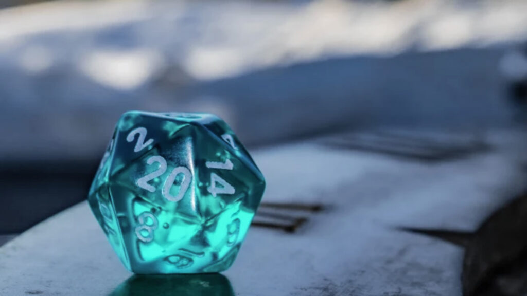 A blue, semi-transparent, 20 sided dice sits atop a sun dial.